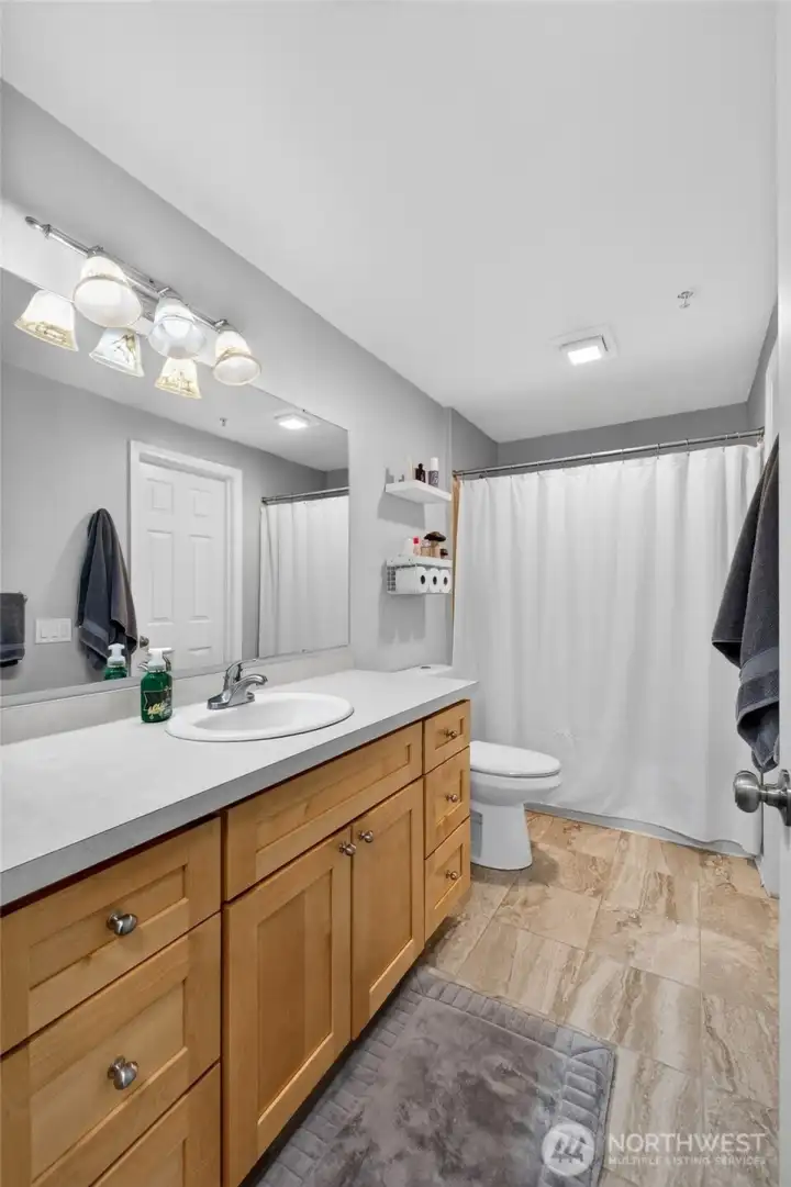 The bathroom features a huge vanity, tons of counter space and storage!