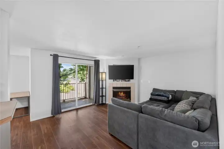 The living room offers access to the private patio and a warm, cozy fire.