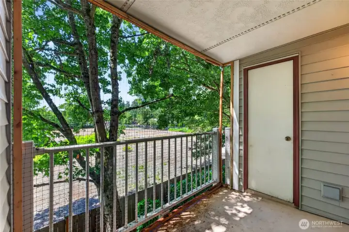 a quiet and private patio with a storage closet