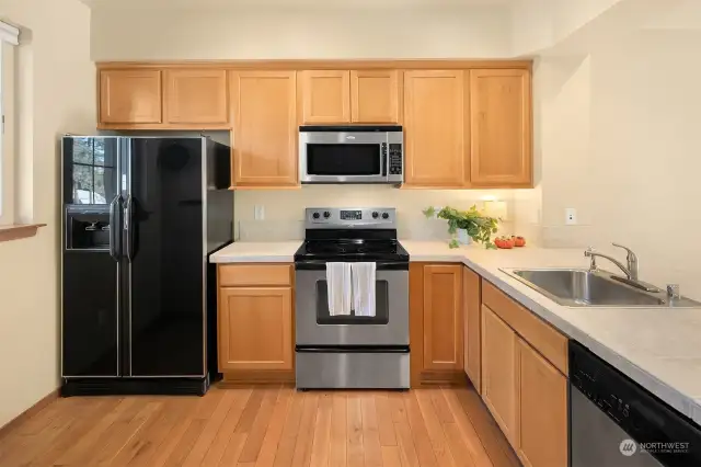 Large open kitchen area with stainless appliances.