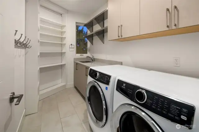 Laundry located on the top floor with ample storage plus sink.