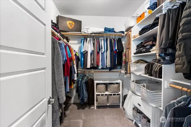 Primary walk in closet with built in storage