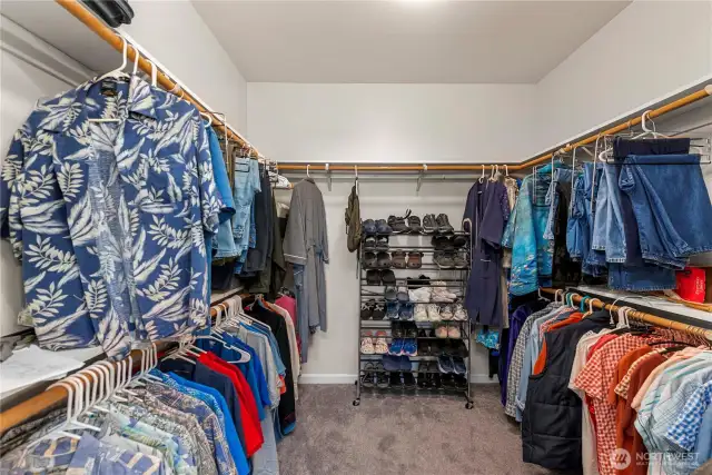 Big walk in closet with closet system.
