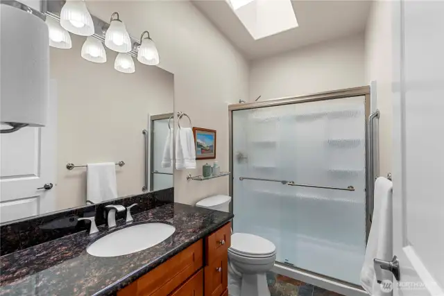 The guest bathroom has a large walk in shower.