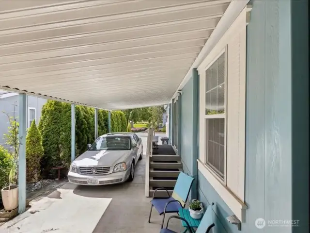 Covered carport with room for two cars.  Side entry to the right.