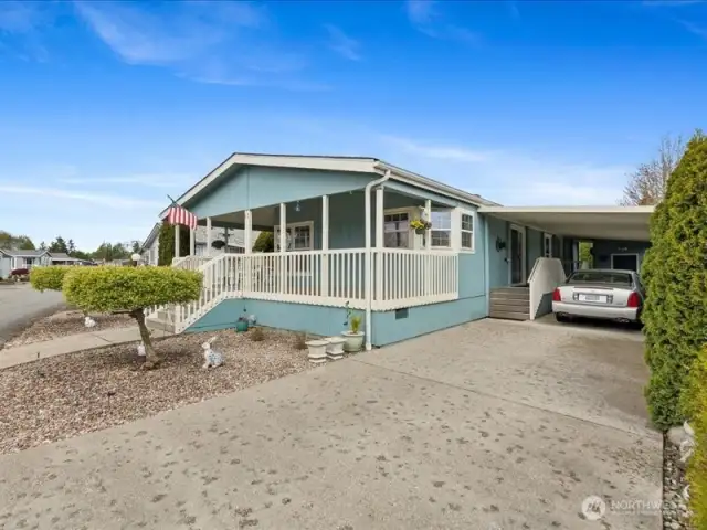 Very well maintained home with welcoming covered front porch, private driveway with carport for 2.