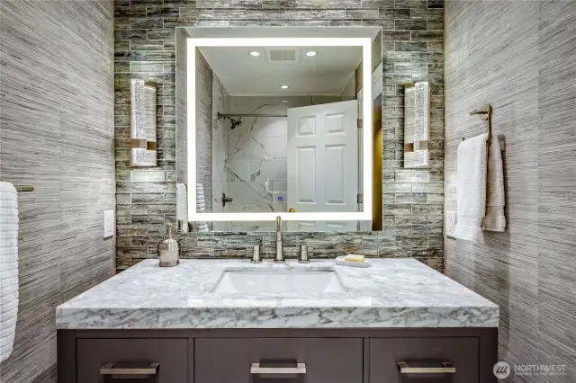 Upstairs full bath updated with beautiful tile work, lighting, and flooring.