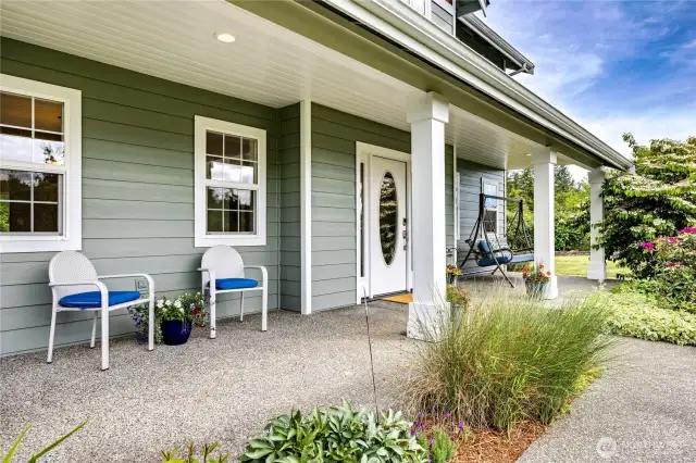 Inviting entry with an oval glass in the front door, all within a large covered patio for taking in the scenery