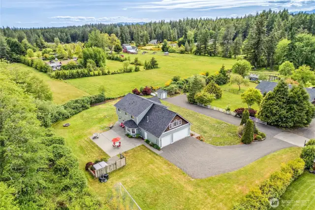 Aerial shot of the home on a shy acre surrounded by farmlands.