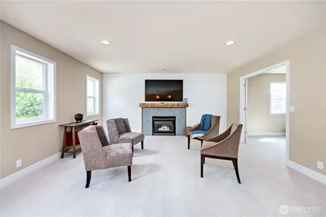 Living room flows from the kitchen with a tile surround gas fireplace-  Fresh neutral paint and new carpeting abd pad throughout the house