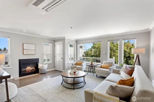 Plenty of windows flank the large living room with access to the front deck.