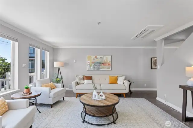 The living room is spacious and separated from the dining and eating areas.