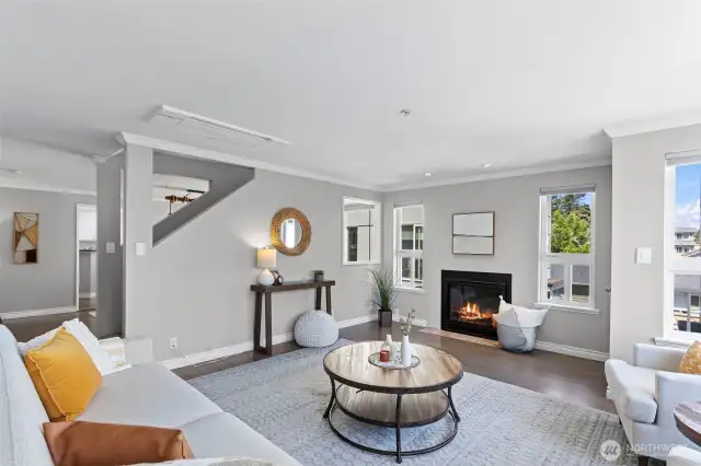 The gas fireplace provides a focal point. This main level has white oak flooring throughout and a pleasant designer wall color.