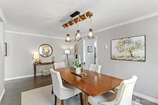 The entertainment sized dining room features a 3-light linear chandelier and has easy access to the kitchen.