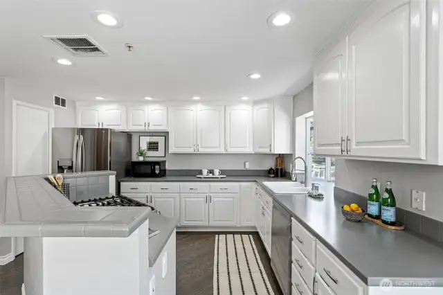 The large kitchen has lots of storage, prep areas and spaces for small appliances.