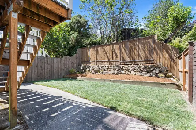 The fully fenced back yard with patio is easy to maintain and pet-friendly.