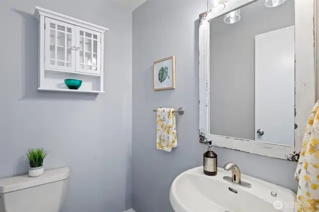 The powder room on the main level features an automatic faucet and conveniently situated for guests.