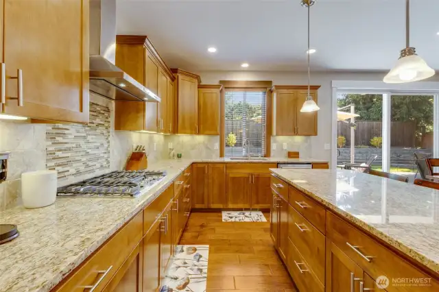 The inviting kitchen also includes a gas stove, granite counters, and soft close cabinets and drawers.