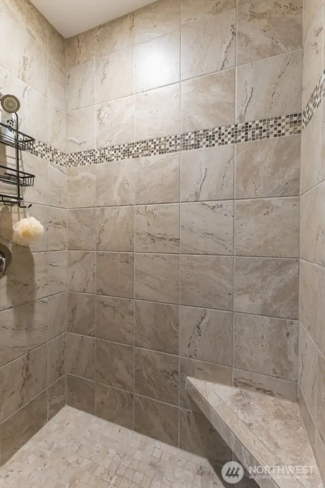 Private shower area with bench.