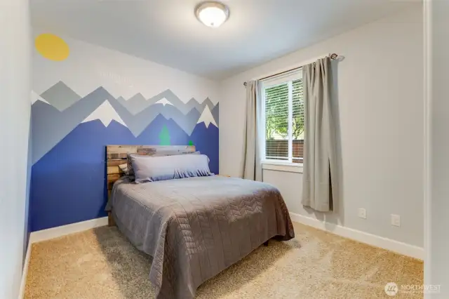 Bedroom 2 with custom accent wall and walk-in closet.