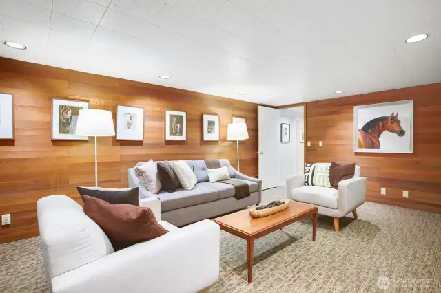 Family room has warm wood walls