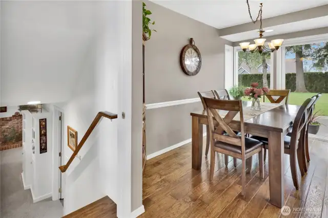 The dining area sits just off the kitchen, with the entrance to the basement conveniently located to the left.