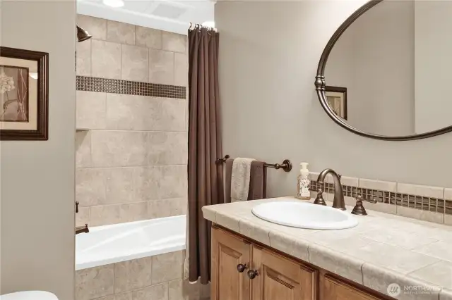 The upstairs full bathroom boasts a beautifully tiled shower and a floor with radiant heating for added comfort.