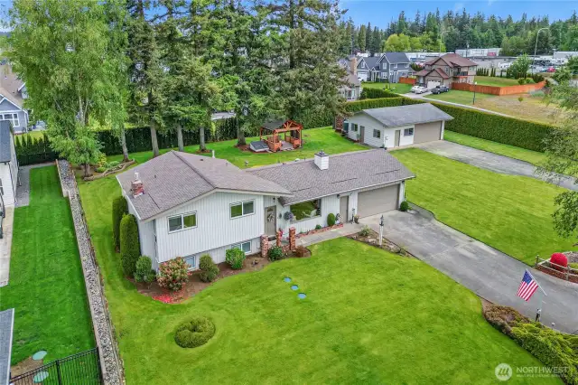 Lots of room means lots of possibilities! This property sits on a double lot—each ½ acre—with water shares included, offering endless options for your dream home, spec home, or conversion of shop to an ADU.