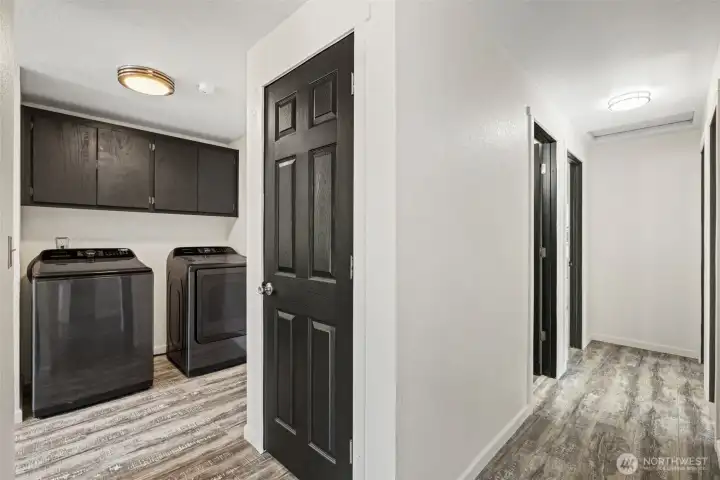 Hallway leads to the bedroom on the right, with the hot water tank conveniently located in the closet between the laundry and hallway.