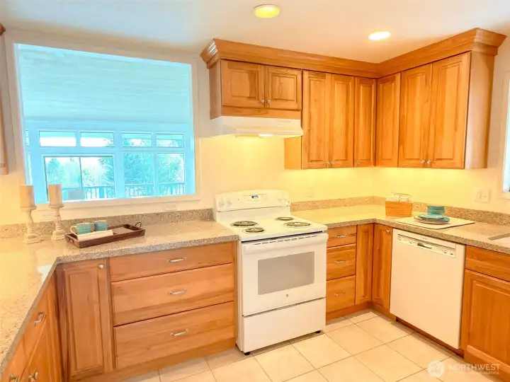 Kitchen with custom wood cabinets and solid surface countertops.