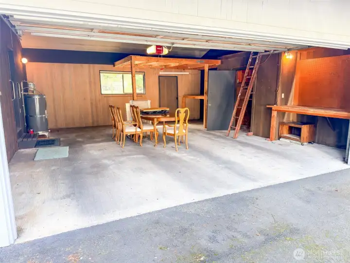 Large 2 car garage with storage areas and locking room.