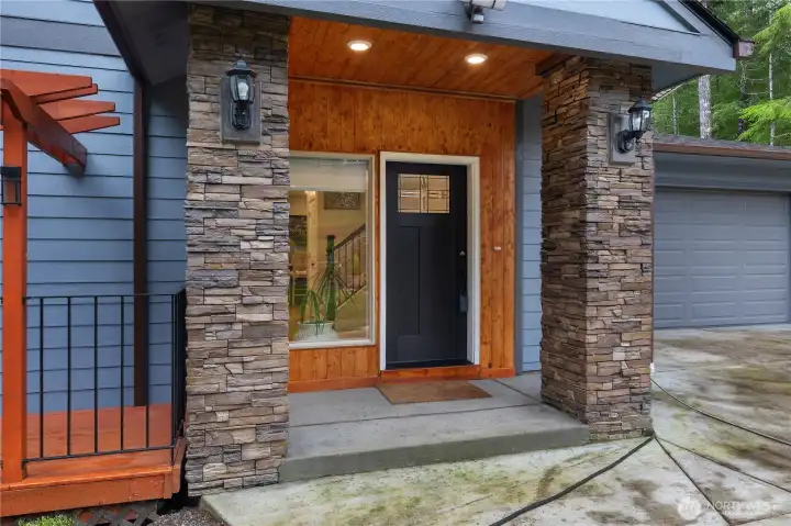 Covered front entry with recessed lighting.