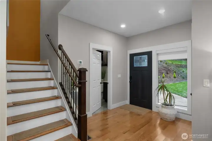 1/2 bathroom by the front door, coat closet opposite.