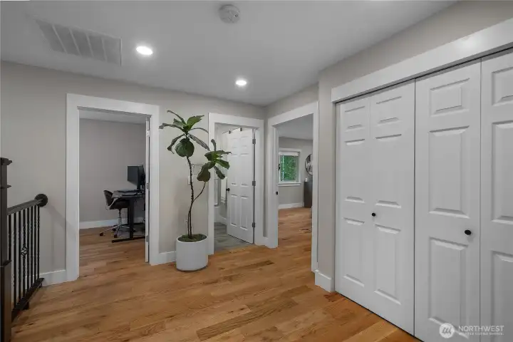 Closets take you to the washer and dryer with shelving builtin.