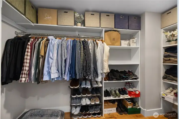 Walk in closet with useful and thought out organizational system.
