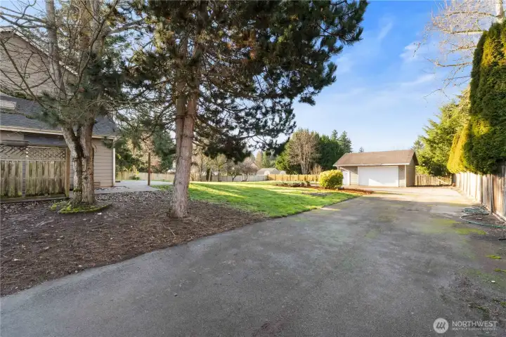 Side gate leads to additional parking area into backyard