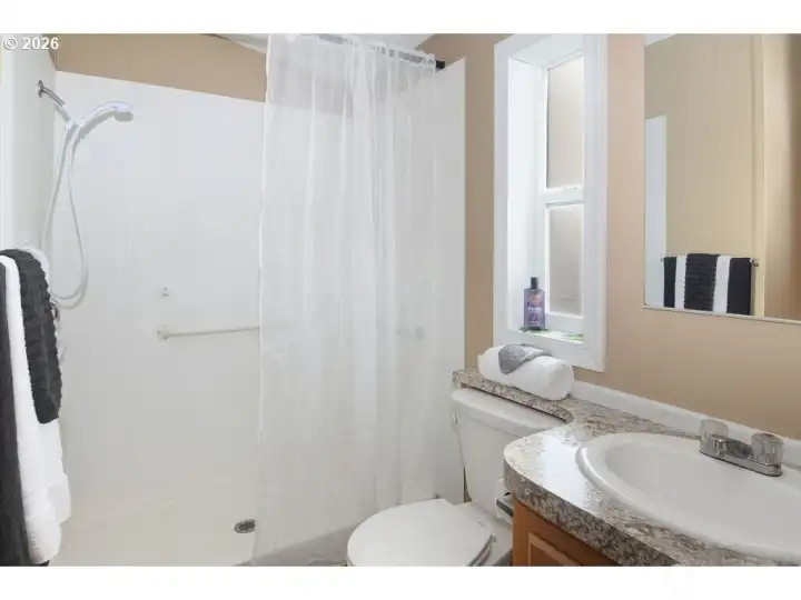 Bathroom featuring walk-in shower.