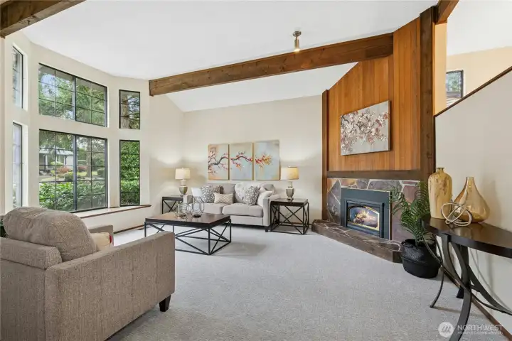 Grand living room with soaring cathedral ceilings and exposed beam details.