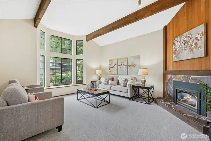 Floor-to-ceiling windows fill the living space with natural light and showcase the surrounding greenery.