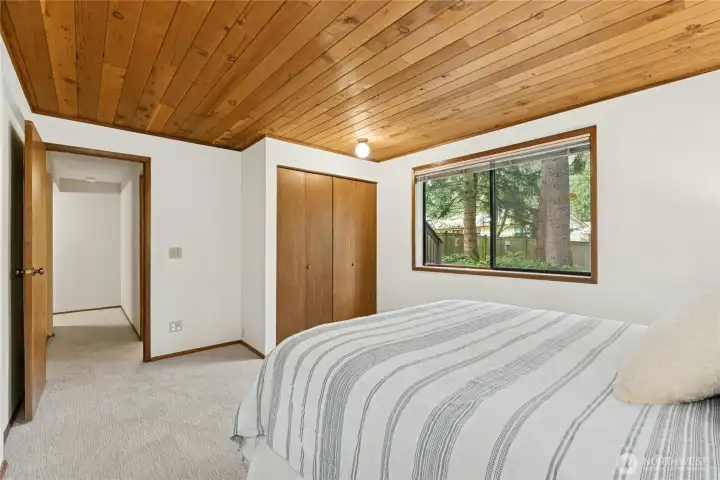 Lower level bedroom providing privacy for guests or multi-generational living.