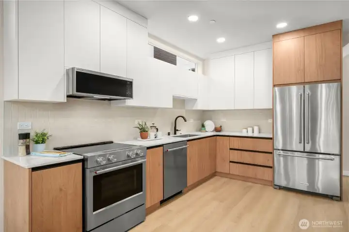 An efficient kitchen for the home chef, featuring high-end stainless appliances, standard in every home