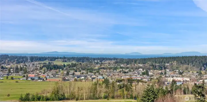 Photo of the view corridor only.  Zoom in to see details of the City of Sequim in the foreground, the Dungeness Spit & Lighthouse visible on the water to the left, the Strait of Juan de Fuca, Vancouver Island in appears in the distance.