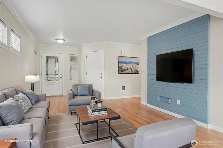 As you enter the home you will find this great living room space with slat accent wall and beautiful flooring, door to your garage is on the right. ***Virtually Staged***