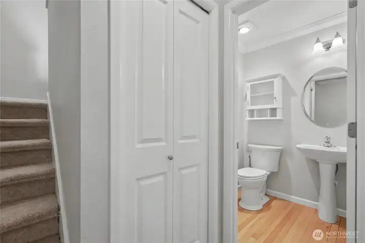 View of your first floor powder room, coat closet, and stairs up.