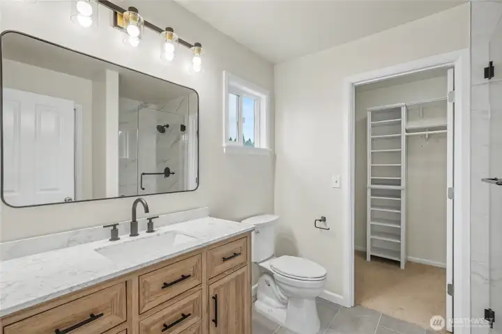 Primary ensuite bath view one, love the cabinetry and the nice walk-in closet with organizers.