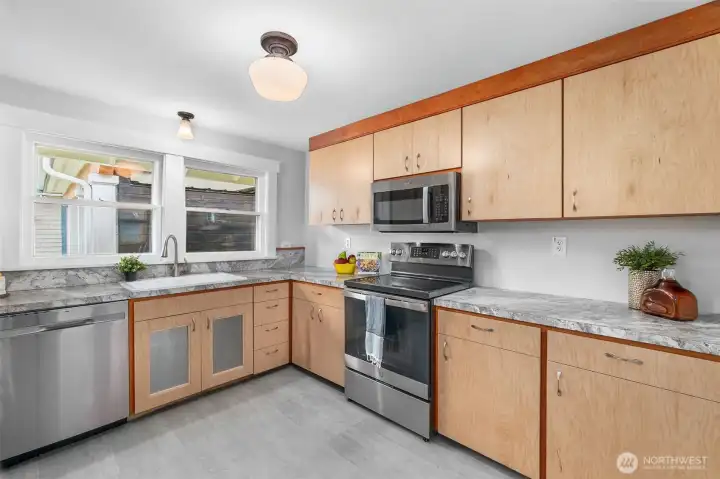 The kitchen has been recently updated with newer custom cabinetry and stainless steel appliances. The kitchen has been recently updated with newer custom cabinetry and stainless steel appliances.