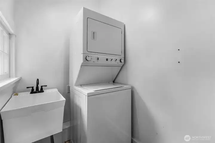 This is the utility room with sink and stacked washer and dryer. This is the utility room with sink and stacked washer and dryer.
