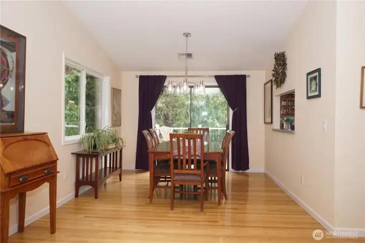 The living room is adjacent to a dining area with sliding doors to the patio and a passthrough to the kitchen.