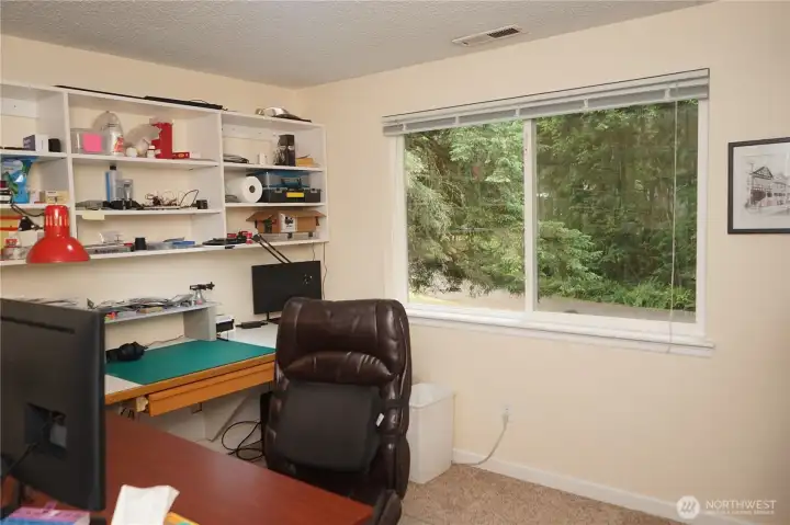 Second bedroom currently used as an office has built in desk and shelving.