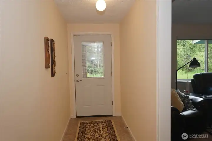 Door from the lower hallway to the back yard.  Another bonus room sits just to the right.